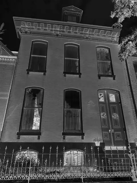 A brick house at night in stark black and white.